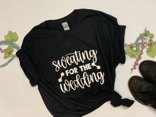 "Sweating for the Wedding" White letters on black 100% cotton shirt.